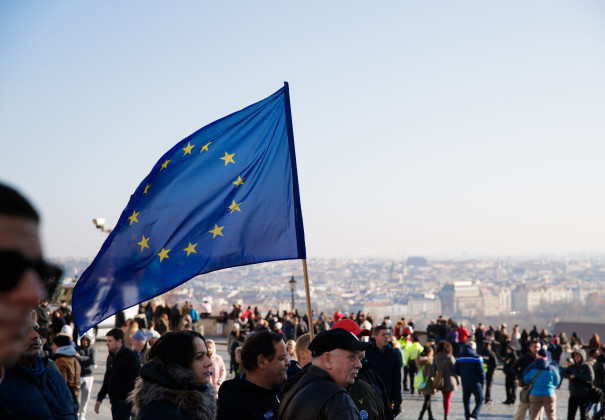 European flag waving amongst people on the street in Prague