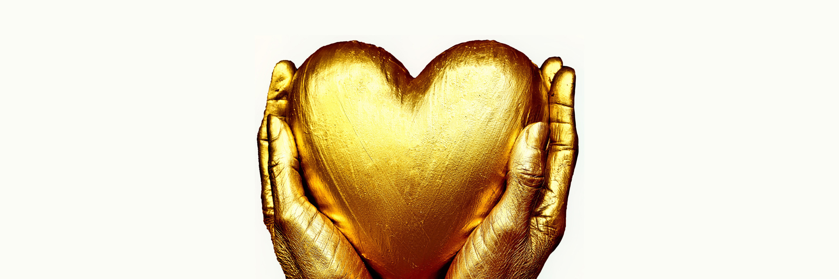two golden hands holding a golden heart