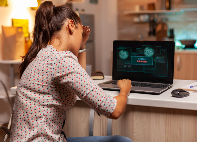 woman sitting in front of her laptop which shows 
